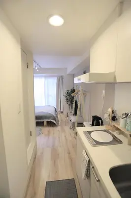 a kitchen with a sink and a room with a bed at 4min walk to JR Yoyogi Sta 8min to Shinjuku MGW in Tokyo
