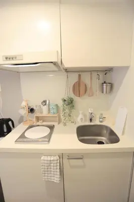a white kitchen with a sink and a counter at 4min walk to JR Yoyogi Sta 8min to Shinjuku MGW in Tokyo