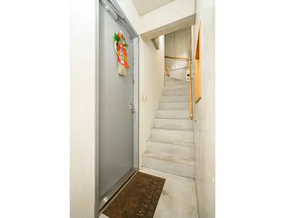 a staircase with a glass door and a rug at \u4e21\u56fd\u99c5\u524d in Tokyo