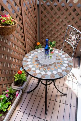 a table with a blue bottle on it on a patio at \u4e21\u56fd\u99c5\u524d in Tokyo