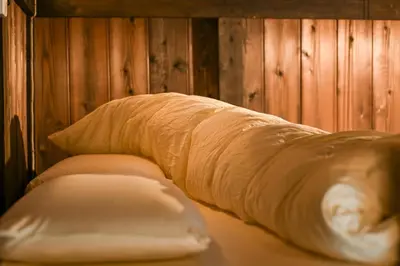 a bed with a bunch of bread in a room at Hotel Suzumeya Tsukiji \u30db\u30c6\u30eb\u3059\u305a\u3081\u3084\u7bc9\u5730 in Tokyo