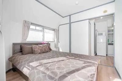 a bedroom with a large bed and a window at Shinjuku Takadanobaba 6 mins walk 2BR Room301 in Tokyo