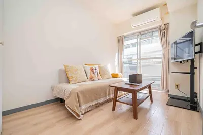 a living room with a couch and a table at Shinjuku Takadanobaba 6 mins walk 2BR Room301 in Tokyo