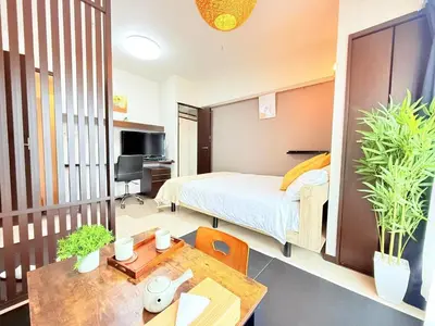 a bedroom with a bed and a desk and a table at Arche de Reve in Tokyo