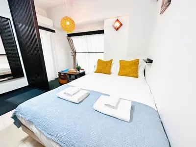a bedroom with a bed with two towels on it at Arche de Reve in Tokyo