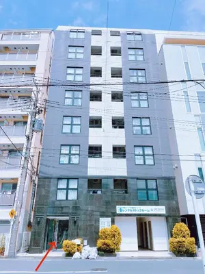 a tall gray building on a city street at Arche de Reve in Tokyo