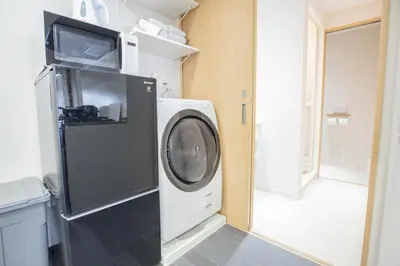 a washing machine with a microwave on top of it at 1min walk to Higashi Shinjuku sta 8PPL Shinjuku Gyoen\u4e36 National Garden\u4e36 Kabukicho\u4e36 Shinjuku Station\u4e36 Golden Gai\u4e36 Tokyo Metropolitan Government Building YYoQA in Tokyo