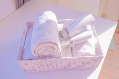 a basket with a hair dryer and a towel at 1min walk to Higashi Shinjuku sta 8PPL Shinjuku Gyoen\u4e36 National Garden\u4e36 Kabukicho\u4e36 Shinjuku Station\u4e36 Golden Gai\u4e36 Tokyo Metropolitan Government Building YYoQA in Tokyo