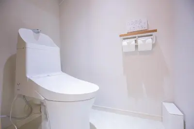 a bathroom with a white toilet and a clock on the wall at 1min walk to Higashi Shinjuku sta 8PPL Shinjuku Gyoen\u4e36 National Garden\u4e36 Kabukicho\u4e36 Shinjuku Station\u4e36 Golden Gai\u4e36 Tokyo Metropolitan Government Building YYoQB in Tokyo