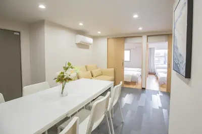 a kitchen and living room with a table and chairs at 1min walk to Higashi Shinjuku sta 8PPL Shinjuku Gyoen\u4e36 National Garden\u4e36 Kabukicho\u4e36 Shinjuku Station\u4e36 Golden Gai\u4e36 Tokyo Metropolitan Government Building YYoQB in Tokyo