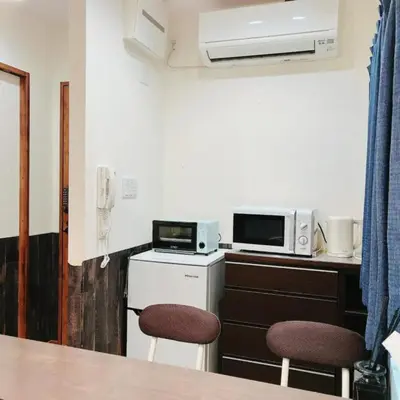 a small kitchen with two chairs and a microwave at 2, Nerima, 1st floor apartment, \u7df4\u99ac in Tokyo
