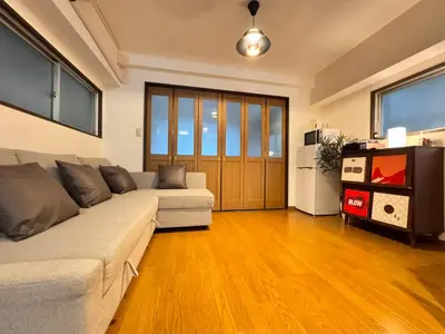 a living room with a couch and a tv at Home Stroy in Tokyo-VENTI Okachimachi \u6771\u4eac\u5c4b\u8a9e in Tokyo