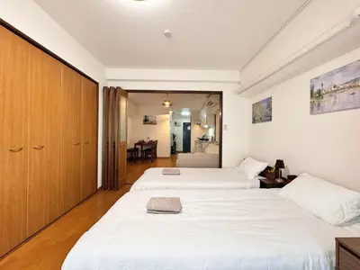 two beds in a room with a bedroom at Home Stroy in Tokyo-VENTI Okachimachi \u6771\u4eac\u5c4b\u8a9e in Tokyo