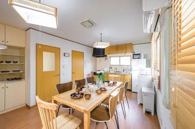a dining room and kitchen with a table and chairs at \u6771\u5411\u5cf6\u4e09\u4e01\u76ee\u65c5\u9928 in Tokyo