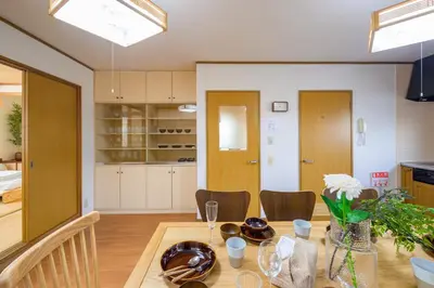a kitchen and dining room with a table and chairs at \u6771\u5411\u5cf6\u4e09\u4e01\u76ee\u65c5\u9928 in Tokyo
