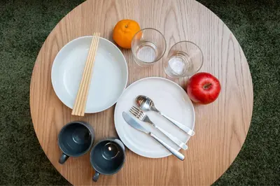 a table with plates and utensils and an apple at MINI HOUSE Tokyo South in Tokyo