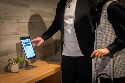 a man is holding a tablet in his hand at MINI HOUSE Tokyo South in Tokyo