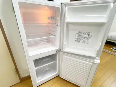 an empty refrigerator with its door open in a kitchen at \u6c60\u888b2\u52065\u4eba\u53ef in Tokyo