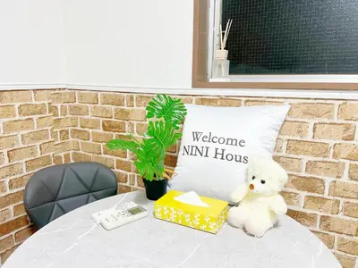 a teddy bear sitting on a table with a box and a pillow at \u6c60\u888b2\u52065\u4eba\u53ef in Tokyo