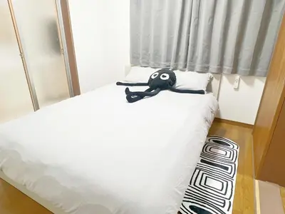 a small bed with a black object sitting on it at \u6c60\u888b2\u52065\u4eba\u53ef in Tokyo