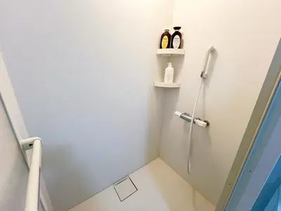 a bathroom with a shower stall with two bottles at \u6c60\u888b2\u52065\u4eba\u53ef in Tokyo