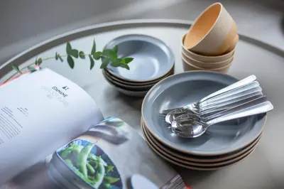 a plate with forks and spoons and dishes on a table at \u3077\u3075\u304b\u6771\u5411\u5cf6 in Tokyo