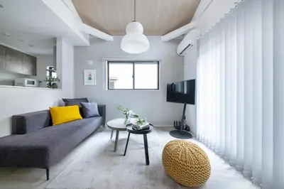 a living room with a couch and a table at \u3077\u3075\u304b\u6771\u5411\u5cf6 in Tokyo
