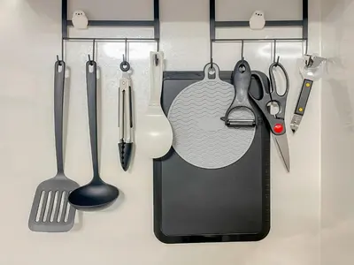 a group of kitchen utensils hanging on a wall at PokaPoka Stay Shinkoiwa R in Tokyo