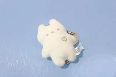 a small white teddy bear on a blue background at PokaPoka Stay Shinkoiwa R in Tokyo