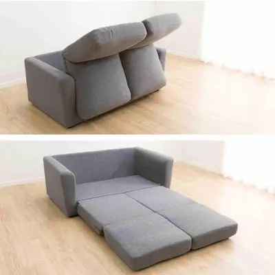 a grey couch sitting in a living room at SunStay Tachiaigawa 2 in Tokyo