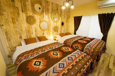 a bedroom with two beds and a wall at AirHOME TOKYO EBISU 102 in Tokyo