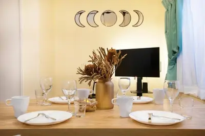 a dining room table with white plates and wine glasses at AirHOME TOKYO EBISU 102 in Tokyo