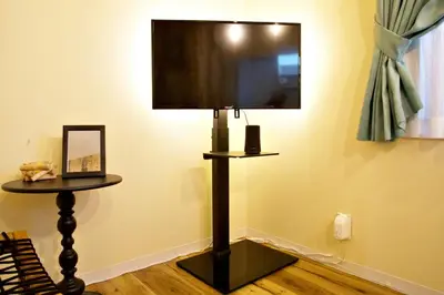 a flat screen tv on a stand in a room at AirHOME TOKYO EBISU 102 in Tokyo