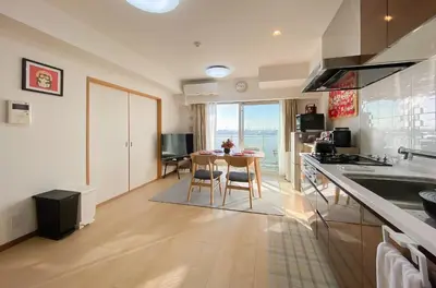 a kitchen with a table and a dining room at \u5b89\u697d\u9014 in Tokyo