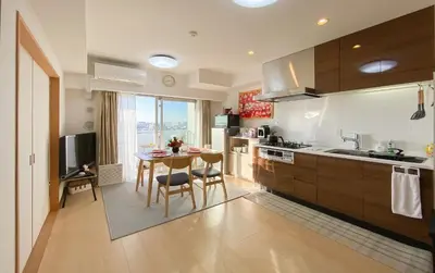 a kitchen with a table and a dining room at \u5b89\u697d\u9014 in Tokyo