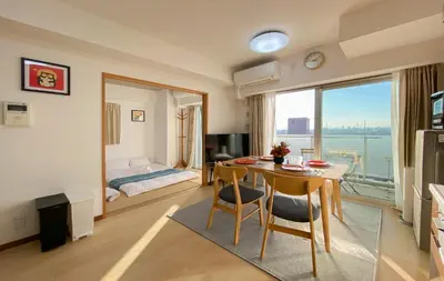 a living room with a table and a bedroom at \u5b89\u697d\u9014 in Tokyo