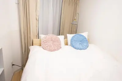 two pillows on top of a white bed at \u82b1\u5bbf\u65b0\u5bbf HANAYADO SHINJUKU in Tokyo