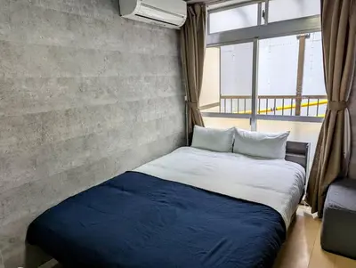 a bed in a room with a large window at Home cruise\u897f\u5c0f\u5c71 in Tokyo