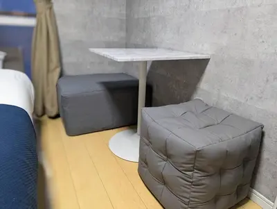 a table and a stool in a room at Home cruise\u897f\u5c0f\u5c71 in Tokyo