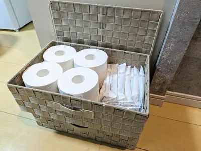 a basket full of toilet paper sitting on the floor at Home cruise\u897f\u5c0f\u5c71 in Tokyo