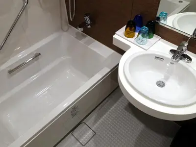 a bathroom with a white toilet and a sink at HOTEL BRILLIO ASAKUSABASHI in Tokyo