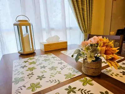 a table with a candle and a vase of flowers at 603 Koiwa Disneyland Airport direct bus in Tokyo