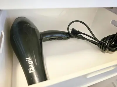 a black object is sitting in a drawer at 603 Koiwa Disneyland Airport direct bus in Tokyo