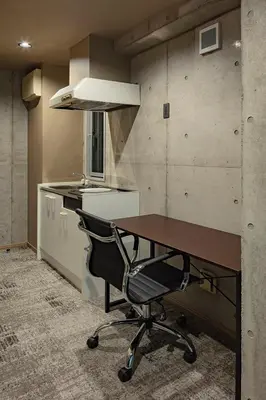 a kitchen with a desk and a chair in a room at The SAUNA Escape Shibuya in Tokyo