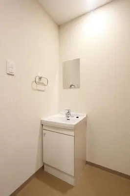 a white bathroom with a sink and a mirror at LUANAHOTEL IN KOUENJI in Tokyo