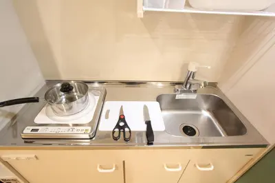 a small kitchen with a sink and a counter top at LUANAHOTEL IN KOUENJI in Tokyo