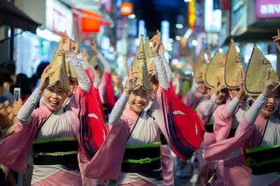 a group of girls in a parade with hats on their heads at LUANAHOTEL IN KOUENJI in Tokyo