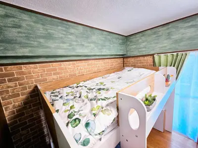 a bedroom with a bed and a brick wall at 703. Disneyland, direct bus to the airport/1minute's walk from the station. in Tokyo