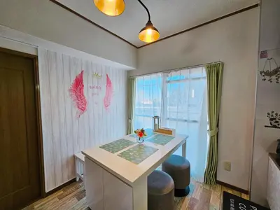 a room with a table and two stools and a window at 703. Disneyland, direct bus to the airport/1minute's walk from the station. in Tokyo