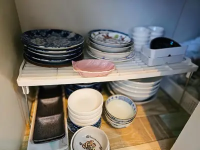 a shelf full of dishes and plates in a cabinet at 703. Disneyland, direct bus to the airport/1minute's walk from the station. in Tokyo